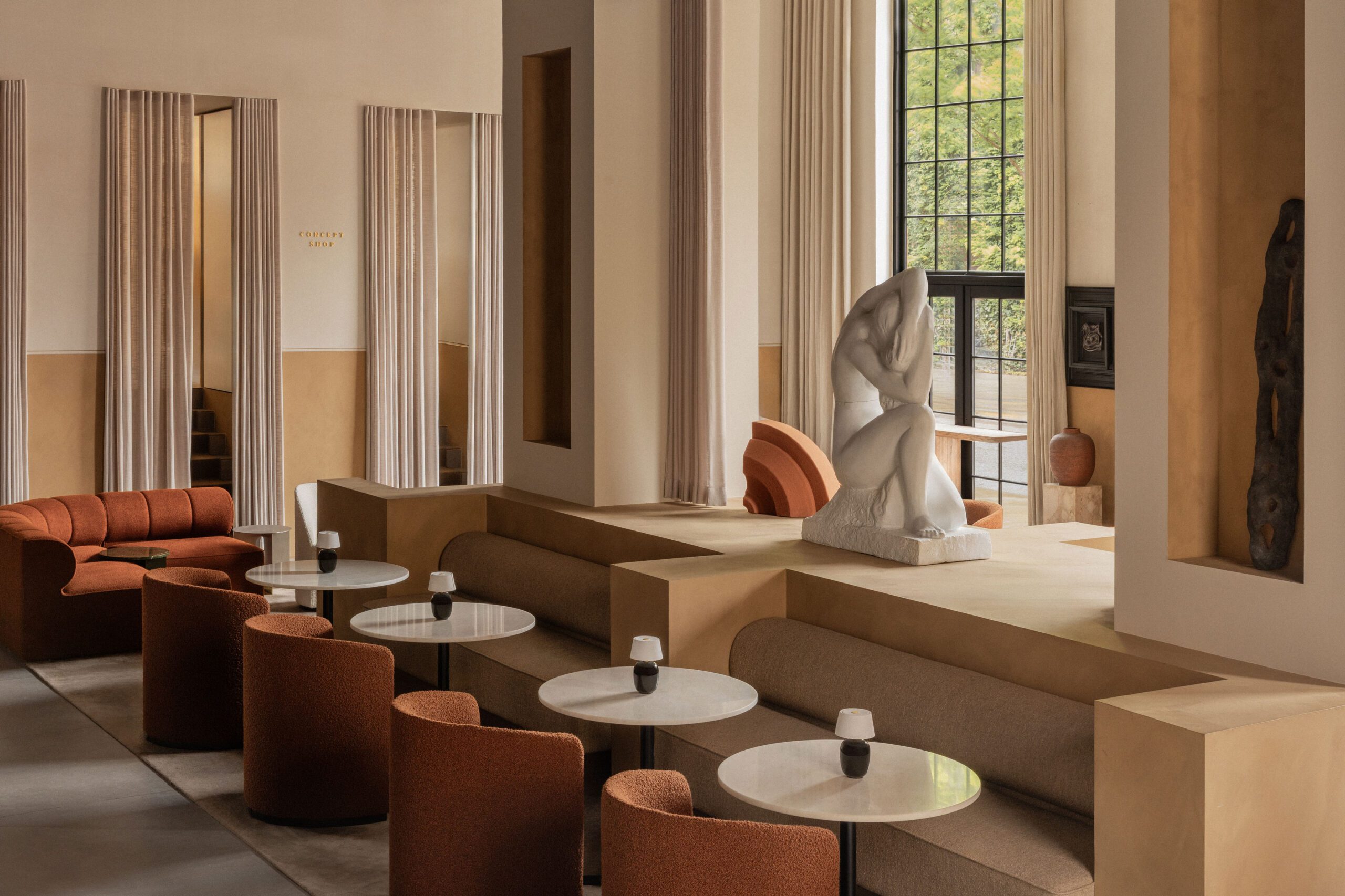 Norm Architects' soft-minimalist interior at Audo House Copenhagen with rust seating and plaster columns