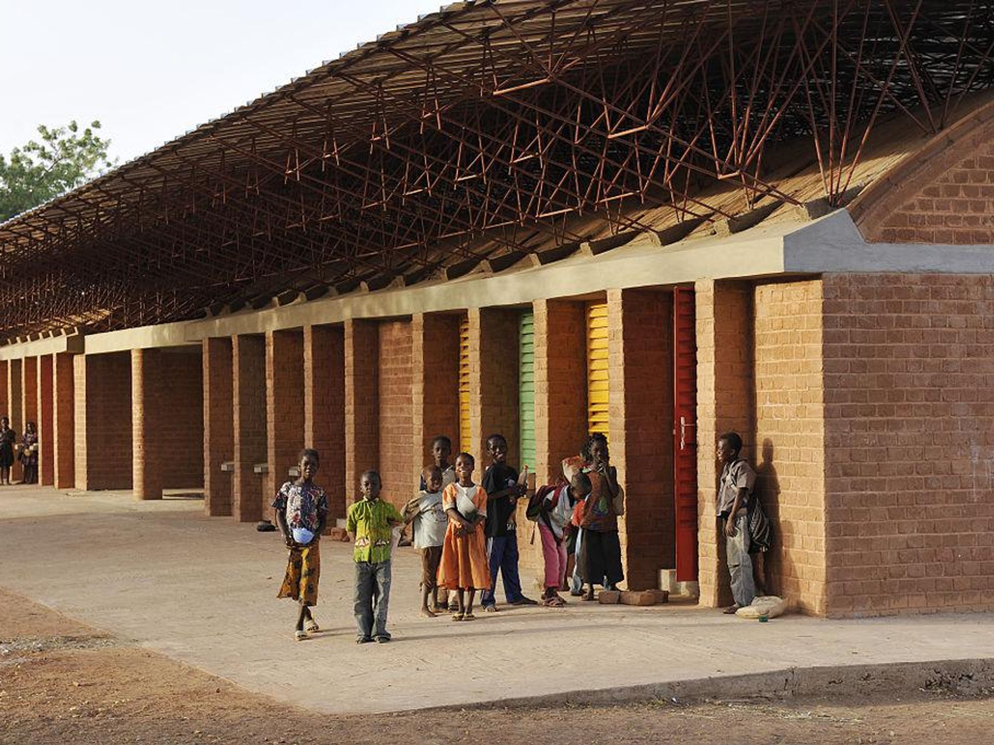Francis Kéré architecture studio works in Burkina Faso, clay brick and laterite stone