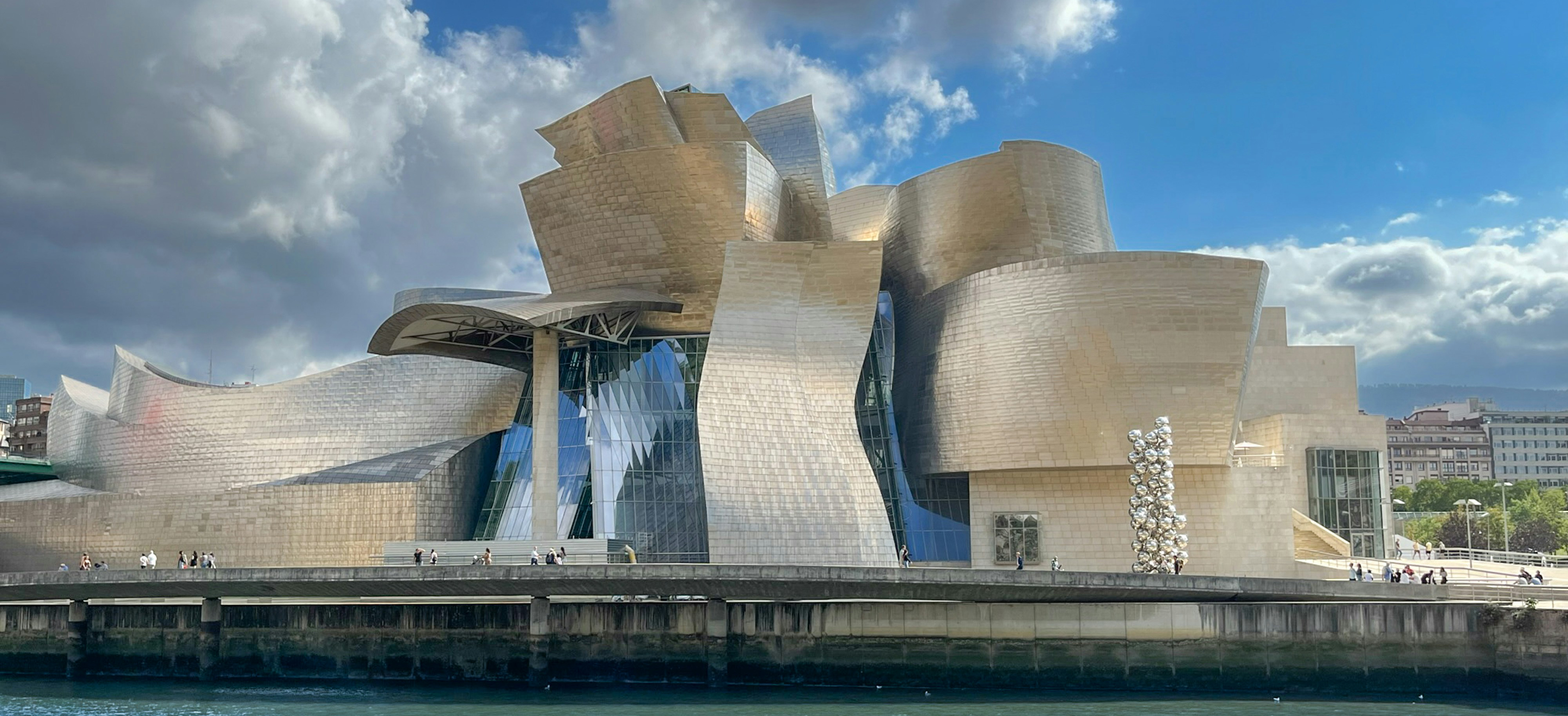 Frank Gehry's institutional architecture lineage from the Vitra Design Museum 1989 through Guggenheim Bilbao 1997, Fondation Louis Vuitton 2014 and Luma Arles 2021 to the 2026 Getty Center tram-station commission