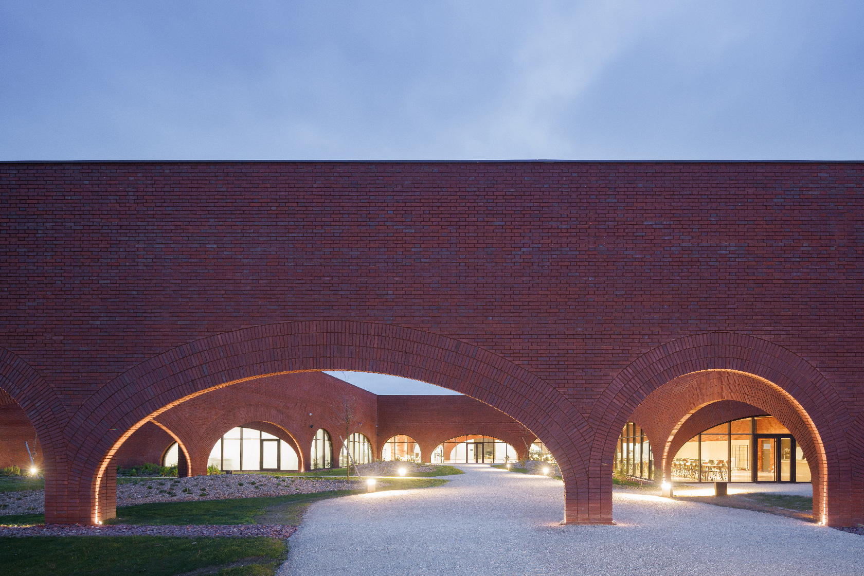 Lina Ghotmeh's hand-combed Stone Garden Beirut, ash-wood Serpentine Pavilion 2023 'À table', and Hermès Ateliers Louviers brickwork as referenced in her Reality is Fluid manifesto