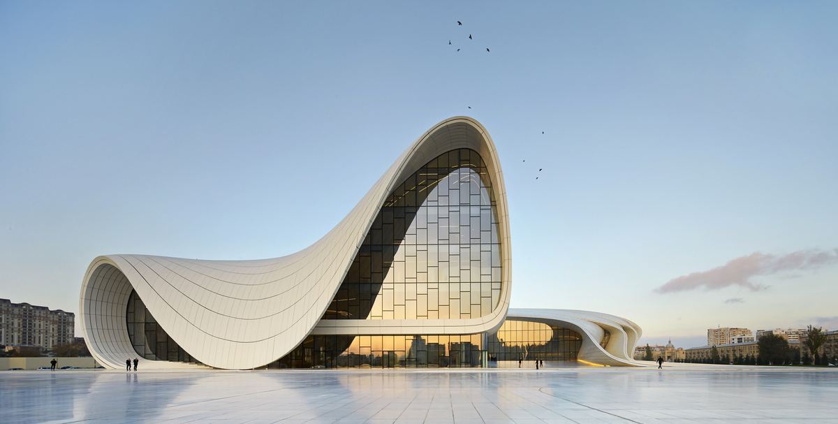 Parametricism lineage diagram tracing FOA's Yokohama International Passenger Terminal through Zaha Hadid Architects to the 2026 Audi Origin pavilion in Milan